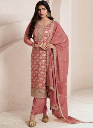 Orange Colored Pakistani Suit is prettified with Embroidery work,Zari And Sequence Work as shown which makes it appear classy. This top is made of Jacquard fabric which is accompanied with Santoon Bottom,Santoon Inner and Chinon dupatta. Women can buy this suit to wear for their parties and functions.