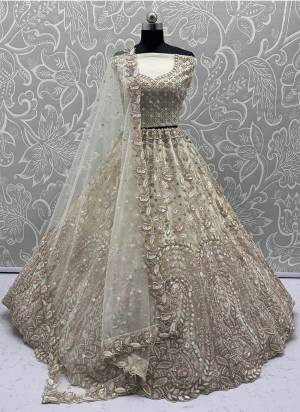 For A Fancy Designer Look,Grab These Lehenga Choli With Dupatta in Fine Colored.These Lehenga And Choli Are Net And Dupatta Are Fabricated On Soft Net Pair.Its Beautified With Fancy Designer Peacock Thread,Sequance,Dori Embroidery With Zarkan Diamond Work. 