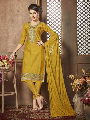 Shine Bright In This Musturd Colored Suit Beautified With Simple And Elegant Embroidery. This Dress Material Is Fabricated On Cotton Paired With Chiffon Fabricated Dupatta. Buy This Suit Now.