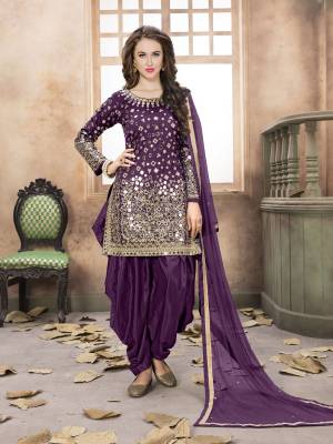 Attract All Wearing This Salwar Suit In Purple Color Paired With Purple Colored Bottom And Dupatta. It Top Is All Over Beautified With Mirror Work Which Gives A Heavy And Attractive To The Suit. Buy It Now.