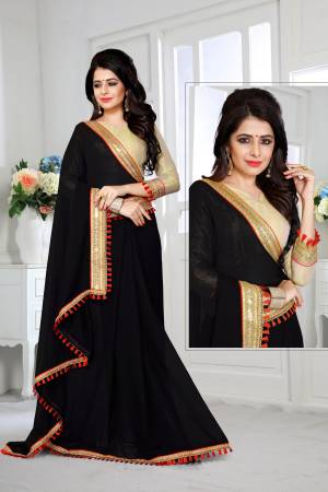 Enhnace Your Beauty Wearing This Black Colored Plain Saree Paired With Golden Colored Blouse. This Saree Is Fabricated On Georgette Paired With Brocade Fabricated Blouse. It Is Beautified With Lace Border Which Is Giving An Attractive Look To The Saree. Buy This Saree Now.