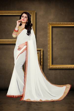 Simple and Elegant Looking Saree Is Here In White Color Paired With Golden Colored Blouse. This Saree Is Fabricated On Georgette Paired With Brocade Fabricated Blouse. It Has Attractive Lace Border Over The Saree. Buy This Pretty Saree Now.