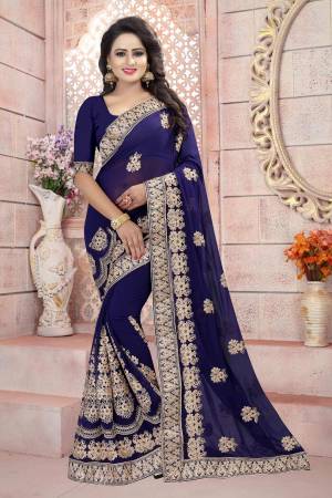 Enhance Your Personality In Dark Colors Wearing This Saree In Navy Blue Color Paired With Navy Blue Colored Blouse. This Saree And Blouse Are Fabricated On Georgette Beautified With Heavy Jari Embroidery All Over It. Buy This Saree Now.