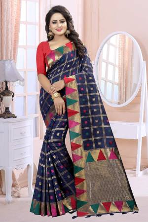 Add This Lovely Saree To Your Wardrobe In Navy Blue Color Paired With Red Colored Blouse. This Saree And Blouse Are Fabricated On Linen Beautified With Prints. It Is Light Weight And Easy To Carry All Day Long.