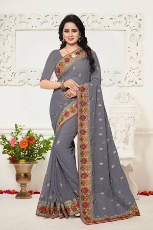 Here Is A Rihc And Elegant Looking Saree In Grey Color Paired With Grey Colored Blouse. This Saree And Blouse Are Fabricated On Georgette Beautified With Contrasting Thread Work Over The Lace Border. 