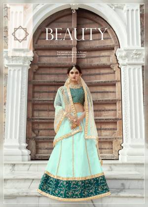 Featuring An Aqua Colored art silk lehenga with zari work and sequins work on hem. It comes along with a Teal Blue blouse in art silk base with shot sleeves featuring heavy zari and sequins embroidery on whole blouse. It has a soft net dupatta with seuqins lining.