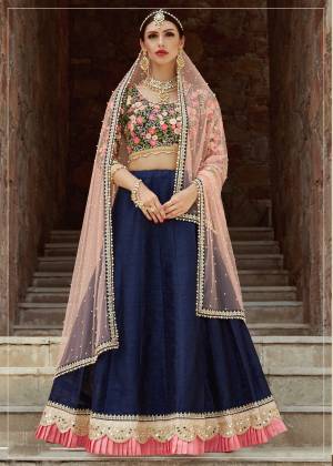 Riot of combination of colors, this bridesmaid lehenga comes in bright navy blue and multi thread color which is truly a bliss. This lehenga is embellished with mirror and dori embroidery on hem with light pink pleats making this lehenga look exquisite. Fabricated with art silk this lehenga is available along with an Dusty Pink pearl work dupatta. Wear it along with some statement jewellary and a pump to complete your bridesmaid look.