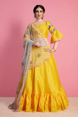 Bright And Appealing Color Is Here With This Designer Lehenga Choli In Yellow Color Paired With Contrasting Grey Colored Dupatta. Its Blouse And Lehenga Are Fabricated On Art Silk Paired With Net Fabricated Dupatta. Buy Simple Lehenga Choli With Attractive Dupatta.