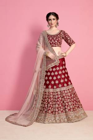 For A Royal Queen Like Look, Grab This Heavy Designer Lehenga Choli In Maroon Color Paired With Light Pink Colored Dupatta. Its Blouse And Lehenga Are Fabricated On Velvet Silk Paired With Net Fabricated Dupatta. Its All Over Heavy Embroidery And Pretty C