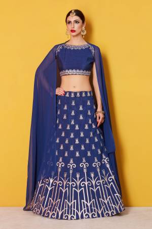 Featuring a blue blouse in art silk with silver gold embroidery and it comes along with blue lehenga in art silk. It is paired with blue plain dupatta in chanderi.