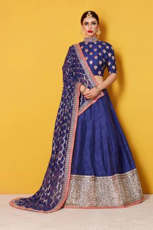 This set features a navy blue art silk zari and sequins work bordered lehenga. It comes along with zari and dori lacework on dupatta and heavy embroidery sequins work on dupatta. Matching blouse with heavy zari work butti.