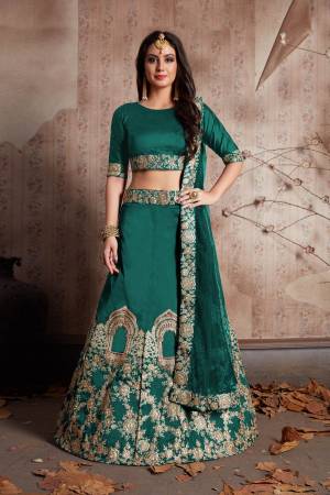 This Lehenga Set Features A Teal green Velvet silk dori work lehenga choli set. It comes along with stone and dori lace work on dupatta and heavy embroidery work on lehenga. Matching blouse with short sleeves.