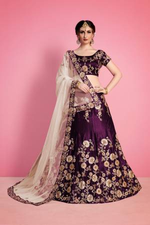 The Purple velvet lehenga blouse set is adorned with all-over floral machine embroidery. It is paired with beige net embroidered dupatta edged with Purple embroidered border. 