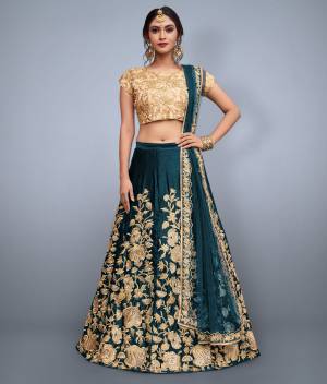 This set features Teal Blue  velvet dori work lehenga choli set. It comes along with cut work dupatta on net base. Matching Beige Colored blouse with heavy dori work.Looks completely heavy work.