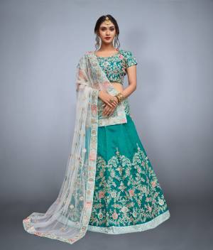 Featuring a Teal green blouse in art silk with dori work embroidery and it comes along with Teal green lehenga in art silk. It is paired with Off-White embroidered dupatta in net.