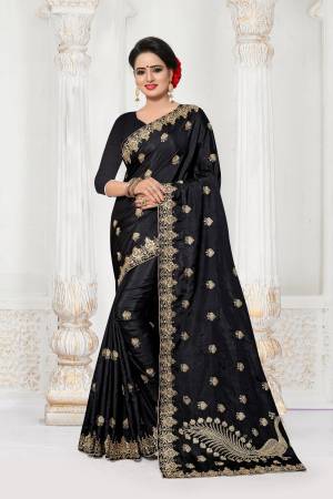 Bold And Beautiful Look Is Here With This Designer Saree In Black Color Paired With Black Colored Blouse. This Saree And Blouse Are Fabricated On Art Silk Beautified With Jari Embroidery And Stone Work. It Has Beautiful Peacock Embroidered Motif Over The Pallu. 