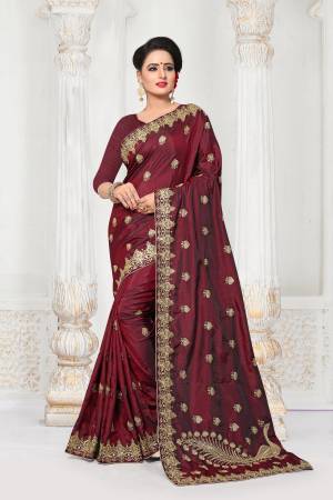 For A Royal Look, Grab This Attractive Designer Saree In Maroon Color Paired With Maroon Colored Blouse. This Saree And Blouse Are Fabricated On Art Silk Beautified With Heavy Embroidery. Buy This Saree Now.