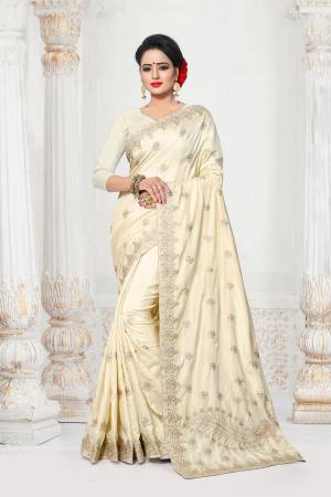 Simple And Elegant Looking Designer Saree In Here In Off-White Color Paired With Off-White Colored Blouse. This Saree And Blouse are Fabricated On Art Silk Beautified With Jari Embroidery And Stone Work.