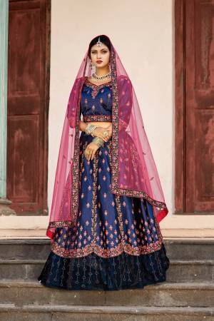 Enhance Your Personality In This Heavy Designer Lehenga Choli In Navy Blue Color Paired With Contrasting Dark Pink Colored Dupatta. Its Blouse And Lehenga Are Satin Based Paired With Net Fabricated Dupatta. 