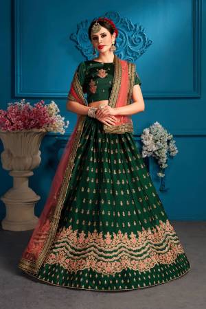 Celebrate This Festive Season Wearing This Heavy Deisgner Lehenga Choli In Dark Green Color Paired With Contrasting Dark Peach Colored Dupatta. Its Blouse And lehenga Are Fabricated On Satin Paired With Net Fabricated Dupatta. Buy It Now.