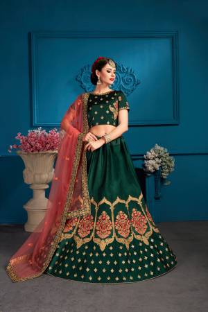 Celebrate This Festive Season Wearing This Heavy Deisgner Lehenga Choli In Dark Green Color Paired With Contrasting Dark Peach Colored Dupatta. Its Blouse And lehenga Are Fabricated On Satin Paired With Net Fabricated Dupatta. Buy It Now.