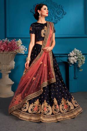 Enhance Your Personality Wearing This Designer Lehenga Choli In Navy Blue Color Paired With Contrasting Dark Peach Colored Dupatta.  Its Blouse And Lehenga Are Fabricated On Satin Paired With Net Fabricated Dupatta. All Its Fabrics Ensures Superb Comfort All Day Long. Buy Now.