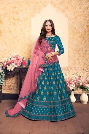 Simple And Elegant Looking Heavy Designer Lehenga Choli Is Here In Blue Color Paired With Contrasting Pink Colored Dupatta. Its Blouse And Lehenga Are Satin Based With Heavy Embroidery Paired With Net fabricated Dupatta. It Is Light In Weight And Ensures Superb Comfort.