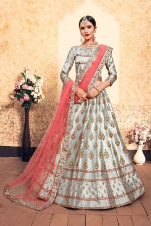 Simple And Elegant Looking Heavy Designer Lehenga Choli Is Here In Steel Grey Color Paired With Contrasting Peach Colored Dupatta. Its Blouse And Lehenga Are Satin Based With Heavy Embroidery Paired With Net fabricated Dupatta. It Is Light In Weight And Ensures Superb Comfort.