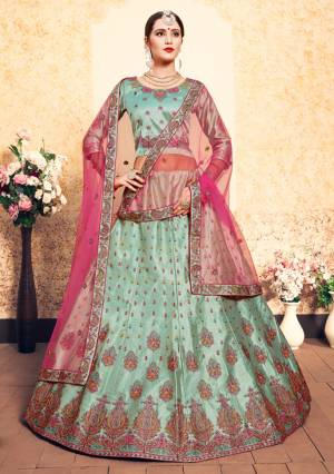 Flaunt Your Rich And Elegant Taste Wearing This Heavy Designer Lehenga Choli In Light Green Color Paired With Contrasting Pink Colored Dupatta. This Lehenga Choli Is Fabricated On Satin Paired With Net Fabricated Dupatta. It Has Pretty Resham Embroidery With Stone Work. Buy Now.