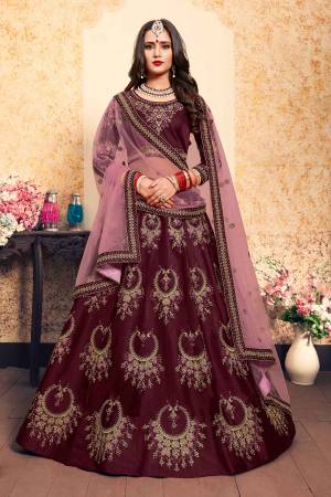 Bright And Visually Appealing Color IS Here With This Heavy Designer Lehenga Choli In Wine Color Paired With Contrasting Pink Colored Dupatta. This Pretty Lehenga Choli Satin Based Paired With Net fabricated Dupatta. Buy This Lehenga Choli Now.