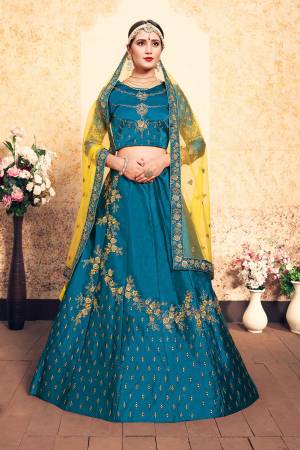 Enhance Yout Personality Wearing This Designer Lehenga Choli In Blue Color Paired With Contrasting Yellow Colored Dupatta. This Pretty Lehenga Choli Is Fabricated On Satin Paired With Net Fabricated Dupatta. 