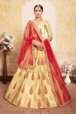 Here Is A Beautiful Designer Heavy Lehenga Choli In Yellow Color Paired With Contrasting Red Colored Dupatta. Its Blouse and Lehenga Are Satin Fabricated Paired With Net Fabricated Dupatta. Grab It Soon.