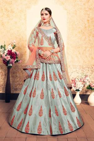 Here Is A Beautiful Designer Heavy Lehenga Choli In Steel Blue Color Paired With Contrasting Peach Colored Dupatta. Its Blouse and Lehenga Are Satin Fabricated Paired With Net Fabricated Dupatta. Grab It Soon.