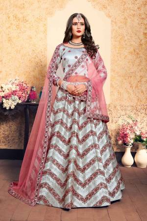 New And Unique Patterned Designer Lehenga Choli Is Here In Steel Blue Color Paired With Contrasting Pink Colored Dupatta. Its Blouse And Lehenga Are Fabricated On Satin Paired With Net Fabricated dupatta. All Its Fabrics Are Light Weight And Easy To Carry All Day Long. 