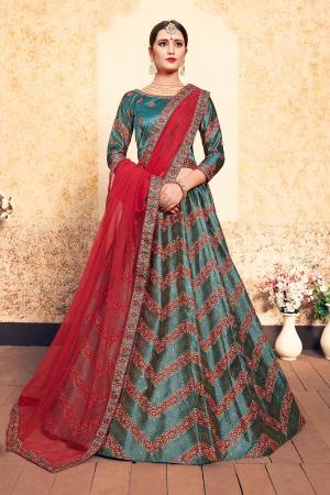 New And Unique Patterned Designer Lehenga Choli Is Here In Teal Green Color Paired With Contrasting Red Colored Dupatta. Its Blouse And Lehenga Are Fabricated On Satin Paired With Net Fabricated dupatta. All Its Fabrics Are Light Weight And Easy To Carry All Day Long. 