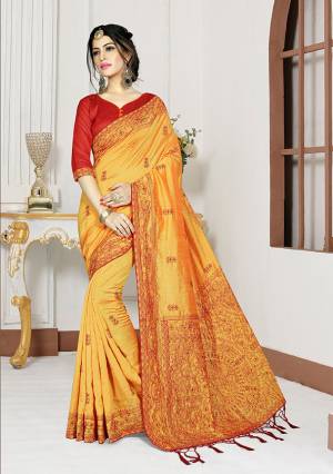 Celebrate This Festive Season Wearing This Designer Saree In Musturd Yellow Color Paired With Contrasting Red Colored Blouse. This Saree And Blouse Are Silk Based Beautified With Heavy Resham Work. Buy It Now.