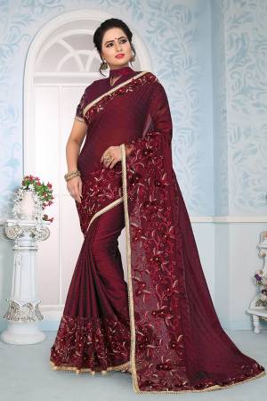 Here Is A Beautiful Royal Looking Saree In Maroon Color Paired With Maroon Colored Blouse. This Saree And Blouse Are Silk Based Beautified With Fancy Embroidery. 