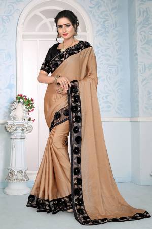 Flaunt Your Rich And Elegant Look Wearing This Designer Saree In Beige Color Paired With Black Colored Blouse. This Saree Is Fabricated On Satin Silk Paired With Art Silk Fabricated Blouse. It Has Fancy 3D Flower With Coding Embroidery. 