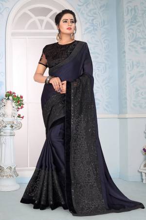 Enhance Your Personality Wearing This Designer Navy Blue Colored Saree Paired With Black Colored Blouse, This Saree Is Fabricated On Satin Georgette Paired With Art Silk And Net Fabricated Blouse. It Is Beautified With Fancy Embroidery All Over.