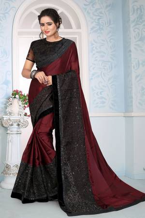 Here Is A Beautiful Royal Looking Saree In Maroon Color Paired With Black Colored Blouse. This Saree Is Fabricated On Satin Georgette Paired With Art Silk And Net Fabricated Blouse Beautified With Fancy Embroidery. 