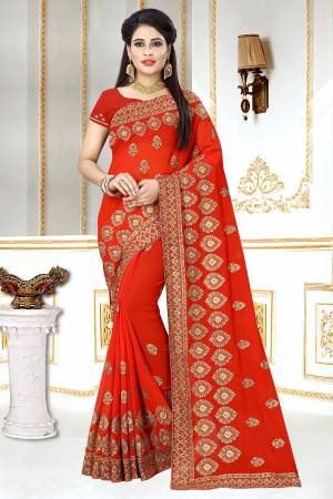 This Wedding And Festive Season, Look The Most Amazing Of All Wearing This Heavy Designer Saree In Red Color. This Saree And Blouse Are Georgette Based Beautified With Heavy Jari Embroidery And Stone Work.