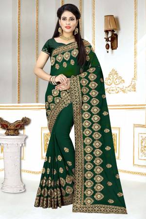 Grab This Beautiful Heavy Designer Saree In Dark Green Color. This Saree And Blouse Are Fabricated On Georgette Beautified Heavy Jari Embroidery And Stone Work. Buy Now.