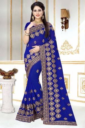 This Wedding And Festive Season, Look The Most Amazing Of All Wearing This Heavy Designer Saree In Royal Blue Color. This Saree And Blouse Are Georgette Based Beautified With Heavy Jari Embroidery And Stone Work.