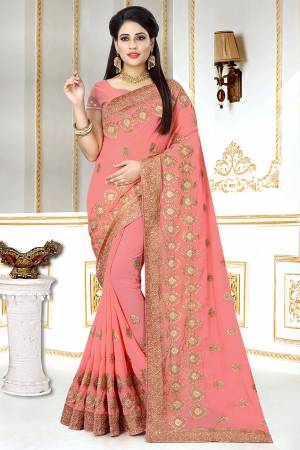 This Wedding And Festive Season, Look The Most Amazing Of All Wearing This Heavy Designer Saree In Peach Color. This Saree And Blouse Are Georgette Based Beautified With Heavy Jari Embroidery And Stone Work.