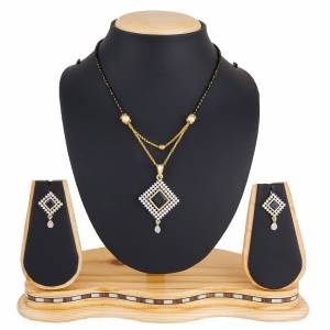 Rich and Elegant Looking Designer Mangalsutra Set In Here In Golden Color Beautified With Diamond Work. It Also Comes With A Pretty pair Of Earrings. Buy Now.