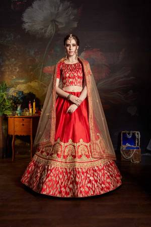 Get Ready For The Upcoming Wedding Season With This Designer Heavy Lehenga Choli In Red color Paired With Beige Colored Dupatta. Its Blouse And Lehenga Are Fabricated On Satin Paired With Net Fabricated Dupatta. It Has Pretty Attractive Embroidery All Over It. 