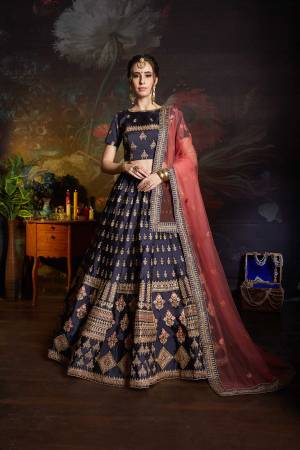 Enhance Your Personality Wearing This Heavy Designer Lehenga Choli In Navy Blue Color Paired With Contrasting Pink Colored Dupatta. This Heavy Embroidered Lehenga Choli Is Fabricated On Satin Paired With Net Dupatta. Its Fabrics Are Soft Towards Skin And Easy To Carry All Day Long. 