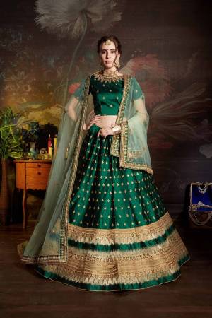 Catch All The Limelight Wearing This Heavy Designer Lehenga Choli In Dark Green Color Paired With Light Green Colored Dupatta. This Lehenga Choli Is Fabricated On Satin Beautified With Heavy Embroidery Paired With Net Based Dupatta. Buy Now.