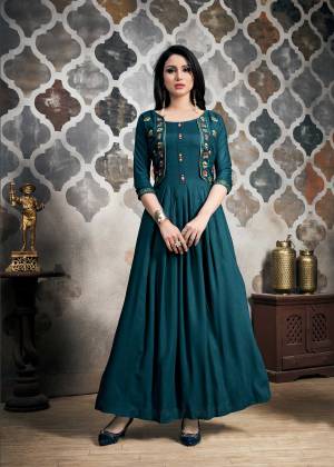 A Must Have Shade In Every Womens Wardrobe Is Here With This Designer Readymade Gown In Teal Blue Color Fabricated On Khadi Slub. It Is Beautified With Multi Colored Thread Work. Buy Now.