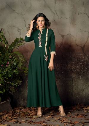 Celebrate This Festive Season With Beauty And Comfort Wearing This Designer Readymade Gown In Pine Green Color Fabricated On Rayon. It Is Beautified With Thread Work. Its Fabric Is Soft Towards Skin And Easy To Carry All Day Long. 